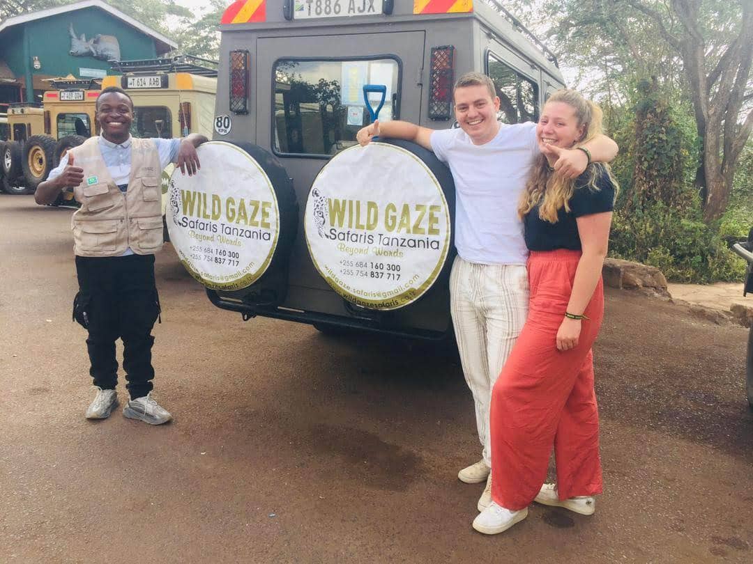 Wild Gaze guide and guests beside the safari vehicle